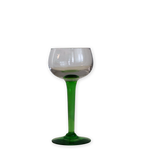A stemmed wine glass with a clear glass bowl and a vibrant green stem and base, isolated on a white background.